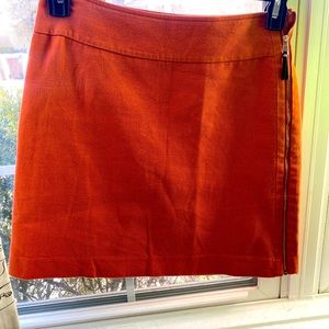 Ann Taylor true pumpkin colored skirt with full exposed gold zipper.